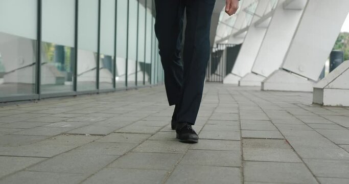 Close-up on man's legs confidently in stylish suit Legs move forward with freedom that speaks volumes his walk symbol of poise. Movement of his legs embodies free determined spirit.