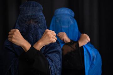 Two Muslim women in Burka or Burqa, tradition cloths in Afghanistan and West Pakistan showing fist...