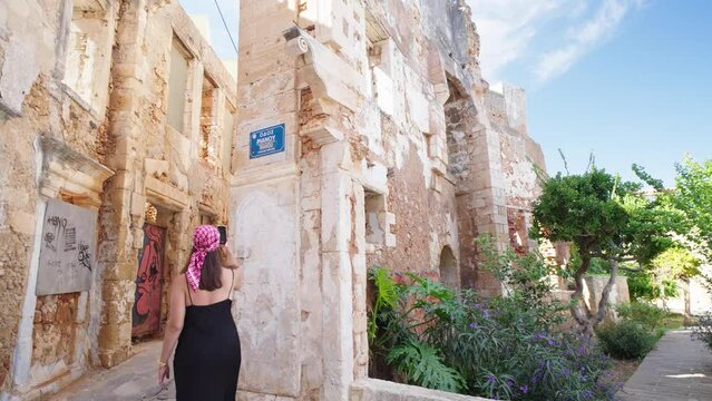 Woman tourist enjoying Bay Of Chania At Sunny Summer Day In Crete, Greece

