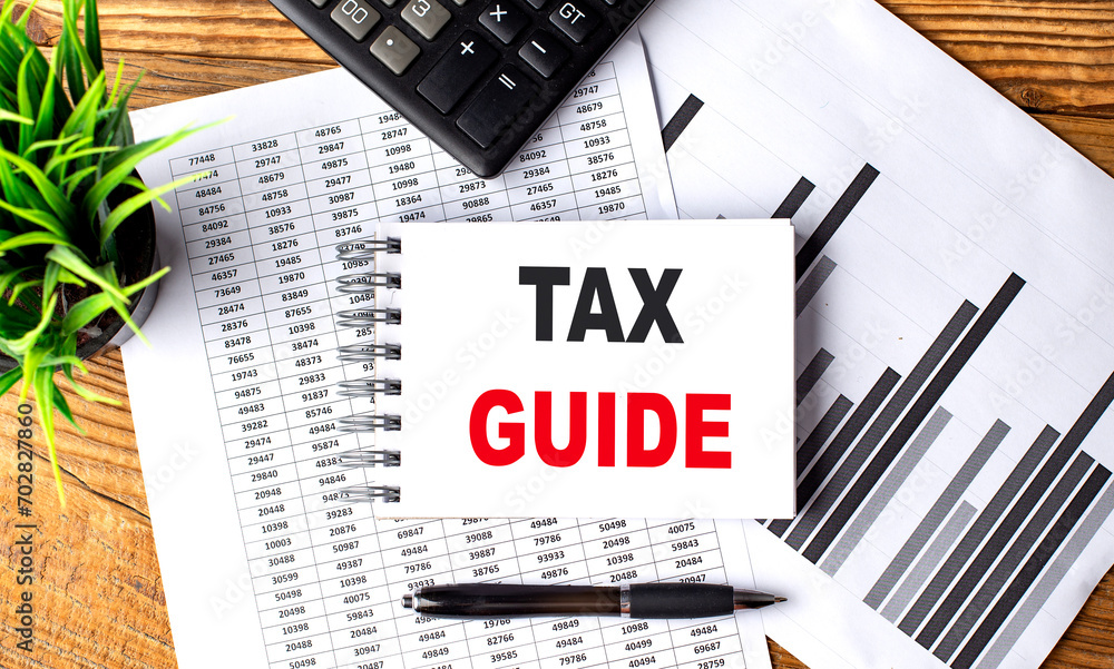Poster tax guide text on a notebook with chart and calculator