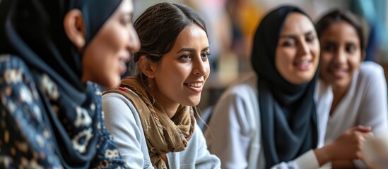 High angle of modern teacher and his immigrant students working on educational English language poster together in group. with copy space image. Place for adding text or design