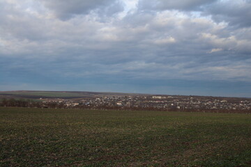 A large field with a city in the distance