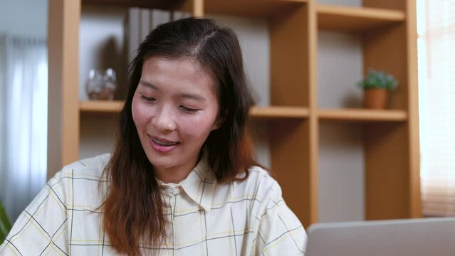 Asian bookkeeper freelance woman or entrepreneur collects bills or tax declare by laptop computer, small business owner, freelancer, employee office worker female lifestyle technology working at home