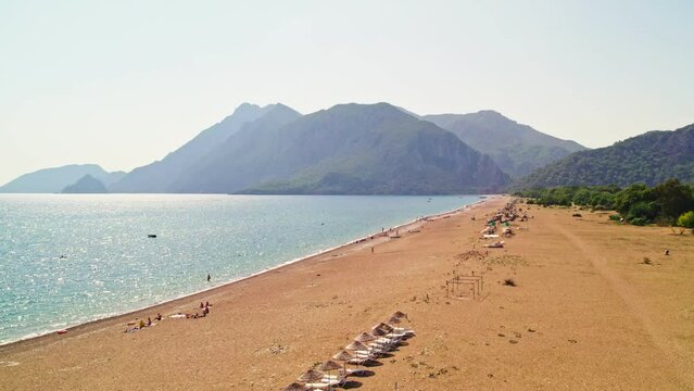 Drone shooting on the beach and down to the sea. Beaches and people swimming in the sea in summer. &Ccedil;ıralı, Antalya coast in the summer of 2023. 4K coast and beach shots.