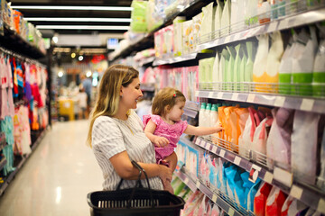 Cheerful mother and baby spending time in shopping in shopping centre