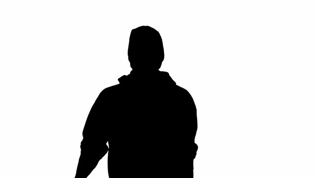 Black silhouette of thief on isolated white background. Male robber in hoodie and balaclava walking, preparing to commit a crime.