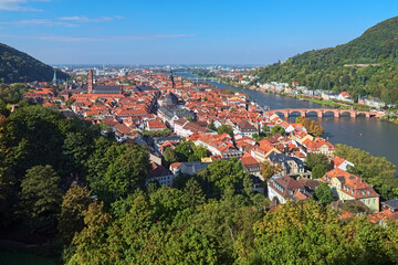 Heidelberg, Germany. High angle view over the Heidelberg Old Town with Jesuit Church, Church of the Holy Spirit and Old Bridge (Karl Theodor Bridge) across the Neckar river. - 702838645