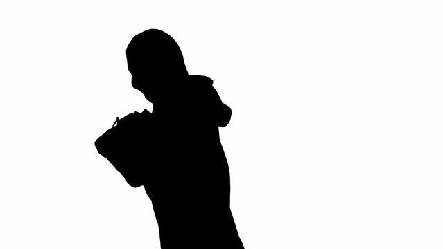 Black silhouette of thief on isolated white background. Male robber in hoodie and balaclava running with a bag in his hands. Concept of crime and thievery. Side view.