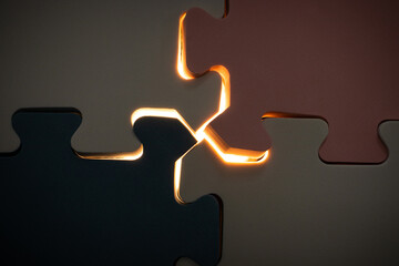 Concept for mistery stuff. Under exposure view of jigsaw puzzle with a glowing light. After some...