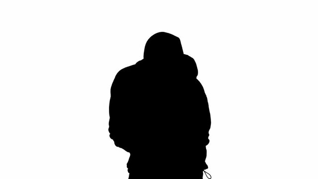 Black silhouette of thief on isolated white background. Male robber in hoodie and balaclava walking with a gun in his hands, preparing to commit a crime.