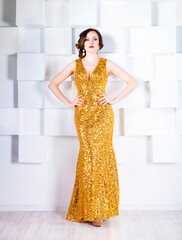 Superstar woman wearing golden shining dress