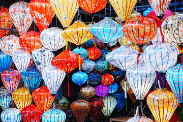 Night view of Colourful cloth lanterns lamp light shades hanging outside in Hoi An, Vietnam -...