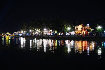 Night view of Colourful cloth lanterns lamp light shades hanging outside in Hoi An, Vietnam -...
