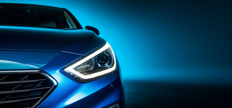 Closeup on headlight of a generic and unbranded blue car