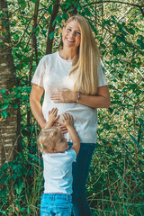 pregnant woman with her child touching the babybelly 