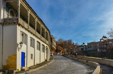 street paved with cobblestone and with traditional Georgian houses and in Avlabari district of...