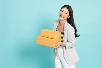 Young Asian woman holding package parcel box isolated on green background, Delivery courier and shipping service concept