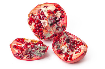 Spoiled red pomegranate with mold. Cut into pieces. White background, isolated. - obrazy, fototapety, plakaty