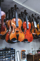 violins are handing in a shop ready for finishing