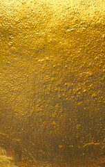 Empty gold or foil wall paint on stone for abstract  background and texture. beautiful patterns, space for work, banner, wallpaper close up.Vertical.