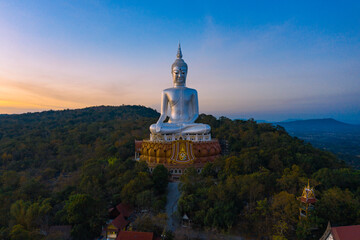 Top view Aerial photo from flying drone.Big Buddha Wat Phu Manorom Mukdahan Thailand.Buddha on the...