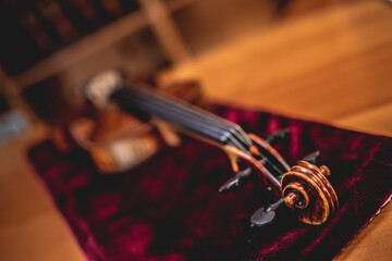 close up shot of a viola laying on velvet at a musical instrument shop