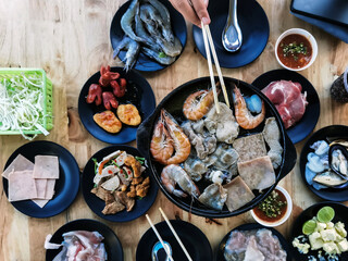 Barbecue seafood beef and pork grill with Butter on charcoal grill pan. Delicious grilled sea food Assorted seafood on grill pan with shrimp, pork and cuttlefish. Delicious grilled food with butter.