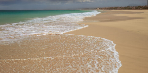 A serene view of the turquoise waters and yellow sands at Praia de Abrabas, Boa Vista, Cape Verde