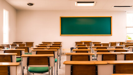 Empty classroom with blackboard chairs and wooden tables with lamps