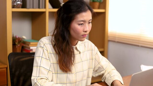 Asian bookkeeper freelance woman or entrepreneur collects bills or tax declare by laptop computer, small business owner, freelancer, employee office worker female lifestyle technology working at home