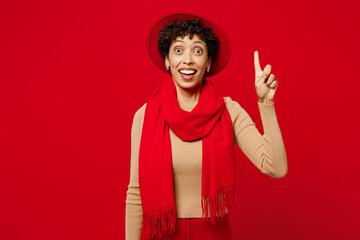 Young insighted smart proactive woman of African American ethnicity wears beige sweater hat scarf...