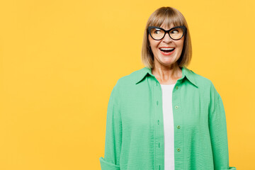 Elderly surprised shocked fun cool blonde woman 50s years old wear green shirt glasses casual...