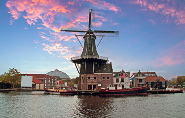 Fototapeta na wymiar Medieval windmill in Haarlem citycenter in the Netherlands at sunset