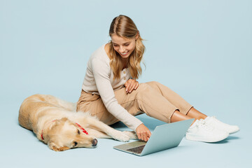 Full body young owner IT woman wear casual clothes sit near her best friend retriever dog hold...
