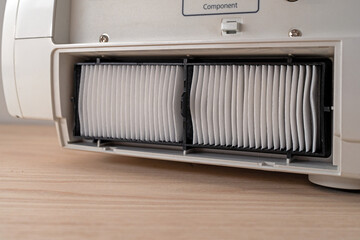 New air filter installed in household appliances. Replacing the dust filter.