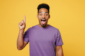 Young proactive man of African American ethnicity he wears purple t-shirt casual clothes hold index...