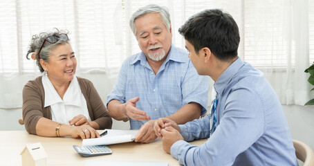 Asian retired senior couple talking with sales agent or banker about financial contract agreement before signing. Living, health insurance or asset investment after retirement