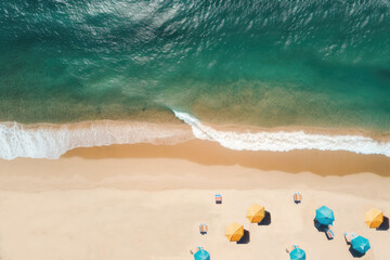 Fototapeta premium Sandy seashore with sun loungers and umbrellas and sea surf. View from above. Copy space. Vacation, travel, resort. Summer period