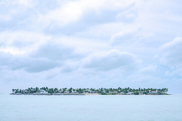 An island, just off the coast of Key West, Florida, set against a brooding, tropical sky