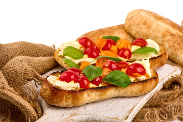 Assorted bruschetta with various toppings, isolated on white background. High resolution image.