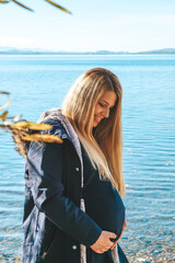 blonde pregnant happy mother outdoor