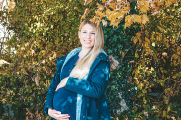 blonde woman pregnant in autumn