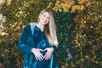 blonde woman pregnant in autumn
