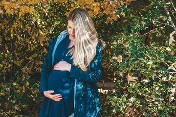 blonde woman pregnant in autumn