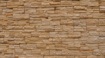 finishing with natural stone in the form of layered tiles in brown shades, a fragment of the texture of a stone exterior surface, a stone background like copy space