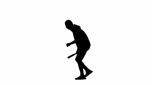 Black silhouette of thief on isolated white background. A male robber in hoodie and balaclava walks with a wooden club in his hands, preparing to commit a crime. Side view.