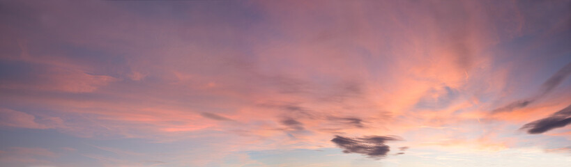 soft panorama sunset sky background with light pink clouds and some grey clouds