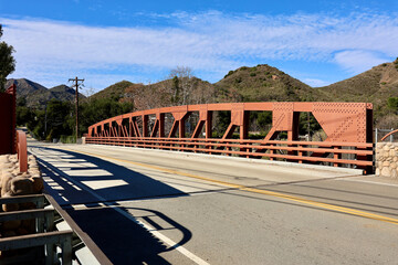country road across a rustic steel bridge