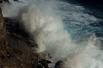 Wave splash on the cliff 