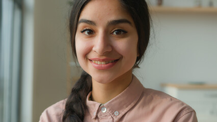 Headshot happy Arabian Indian ethnic millennial woman student girl businesswoman near window female...
